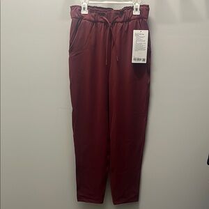 NWT, lululemon stretch high rise 7/8 pants. Maroon color! Open to offers!